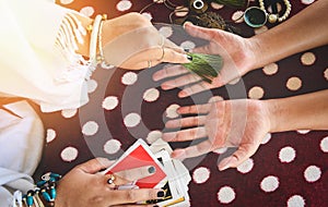 Fortune teller reading fortune lines on hand Palmistry Psychic readings and clairvoyance hands with Tarot cards divination