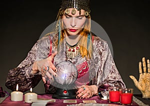 Fortune teller reading future in dark room