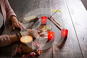 Fortune teller reading a future by tarot cards