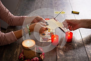 Fortune teller reading a future by tarot cards