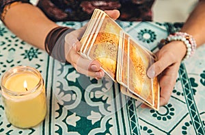 A fortune teller reads with tarot cards. Selective focus.