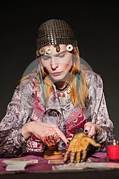 Fortune teller showing palmistry on hand