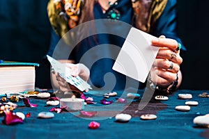 The fortune teller shows an empty white tarot card. Mock up. Copy space. Cartomancy and fortune telling photo