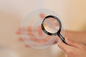 Fortune Teller uses a magnifying glass to look at the horoscope