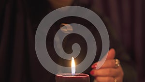 Fortune teller woman in dark room with lots of candles Gives an explaination of future and prediction of fate to a