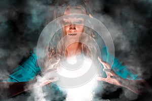 Fortune teller woman with light sphere in her hands