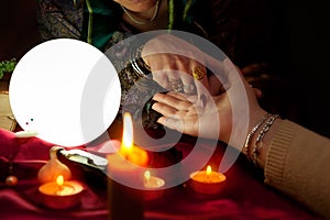 Fortune teller woman point her finger to another woman palm