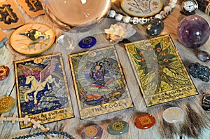 Fortune telling ritual with chakras on stones, tarot cards and runes on witch table