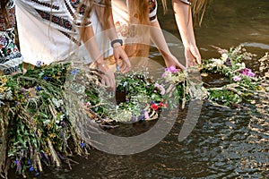 Fortune-telling on wreaths and water, the Ivan Kupala holiday, girls throw wreaths on the water.