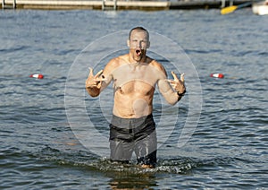 Forty-two year-old Caucasian man in fun pose in the lake at Greenlake Park, Seattle