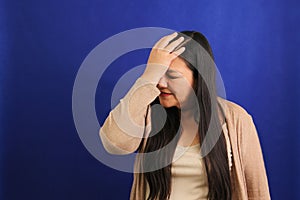 Forty-year-old adult Latina woman suffers from very strong migraine headache due to hormonal changes, stress and depression