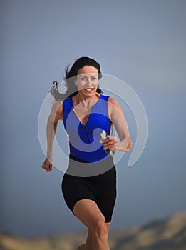Forty year old female triathlete running photo