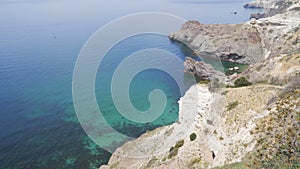 Forward aerial drone video top down bird`s eye view along shoreline of Kaputas Beach