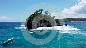 Forward movement to Batu Mejinong rock formation at Crytal Bay beach on Nusa Penida island. Open hole on the side of the