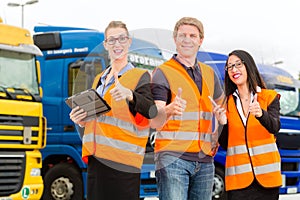 Forwarder in front of trucks on a depot