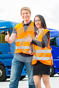 Forwarder in front of trucks on a depot