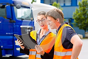 Forwarder in front of trucks on a depot