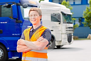 Forwarder in front of trucks on a depot