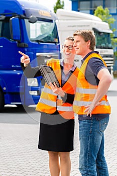 Forwarder in front of trucks on a depot