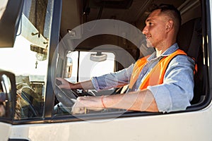 Forwarder or truck driver in drivers cap