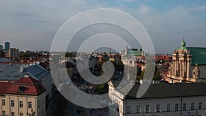 Forwards fly above Krakowskie Przedmiescie. Prestigious street surrounded with palaces and manor houses. Pedestrians