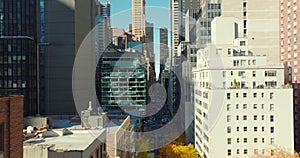 Forwards fly between high rise buildings in city. Autumn colour trees. Manhattan, New York City, USA