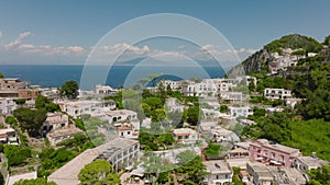 Forwards fly over residential buildings and guesthouses in town. revealing sea coast. Majestic Mount Vesuvius in