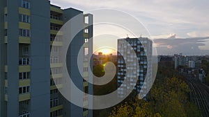 Forwards fly between tall apartment buildings in residential urban borough at sunset. Berlin, Germany