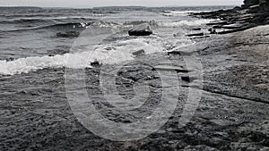 Black and white Lake Champlain waves over chazy limestone photo
