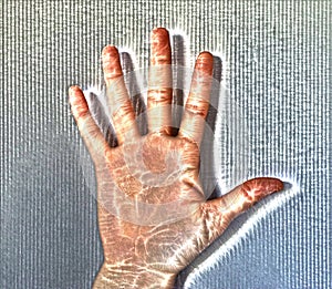 Foto of a glowing human female hand with a kirlian aura showing different symbols