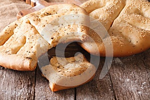 Fougasse French bread with sesame seeds and herbs closeup. Horiz
