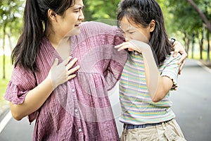 Foul-smelling woman was hug her daughter while her child girl closing nose and can smell the armpit smelly or the body odor foul photo