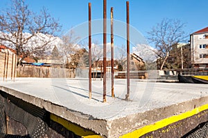 Foundation base of the new house building with reinforcement concrete and steel bars and hydro isolation close up of construction