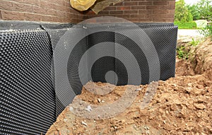 Foundation foam insulation with bitumen waterproofing, damp proofing on the house foundation wall