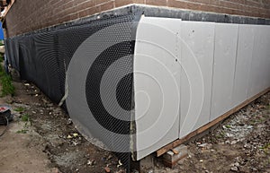 Foundation foam insulation boards with waterproofing, damp proofing. Passive house foundation insulation and waterproofing for