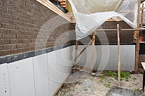 Foundation foam insulation and Damp proofing in problem corner area. House basement, foundation foam insulation details with