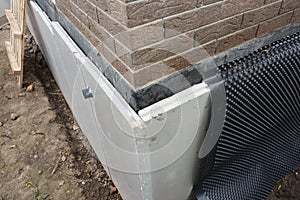 Foundation insulation and Damp proofing in problem corner area. House basement,foundation insulation details with waterproofing photo