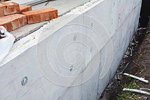 Foundation insulation. House foundation wall construction with foam insulation, damp proof, water proof layers