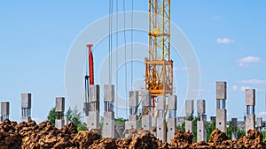 The foundation on reinforced concrete piles and the frame during the construction of a multi-storey building