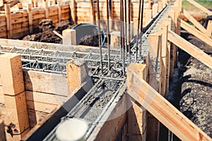 Foundation site of new house, building, details and reinforcements with steel bars and wire rod, preparing for cement pouring