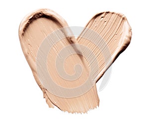 Foundation smears palette close-up. Heart shaped make-up smudge, smear. Cosmetic liquid bb cream beige color smudges