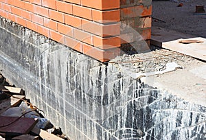 Foundation Waterproofing and Damp proofing Coatings. Waterproofing house foundation with bitumen spray on tar