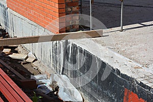 Foundation Waterproofing and Damp proofing Coatings.Waterproofing house foundation with spray on tar.