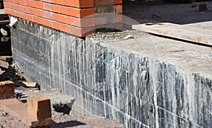 Foundation Waterproofing and Dampproofing Coatings. Waterproofing house foundation. photo