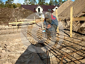 Foundation welding to receive concrete. the welder makes reinforcement for the foundation
