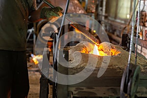 Foundry - ferrous metal is melted in an induction furnace of metallurgical plant photo