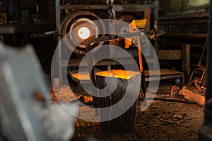 Foundry ladle with molten metal in workshop of metallurgical plant