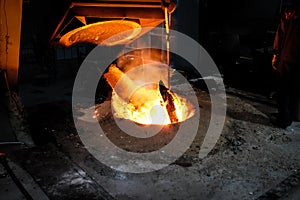 Foundry worker melting metal for casting spare parts