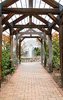 Fountain Beyond Rose Trellis