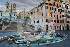 Fountain of Boat and Spanish steps with Trinita dei Monti church in Rome